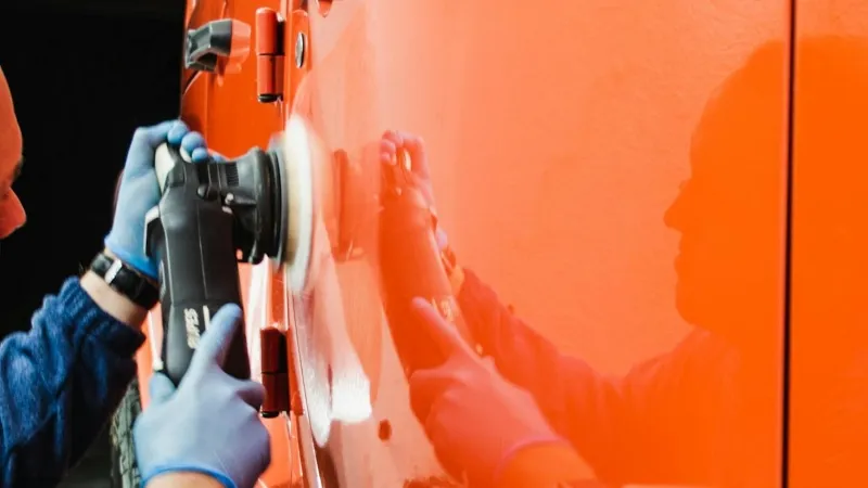 man is polishing truck paint